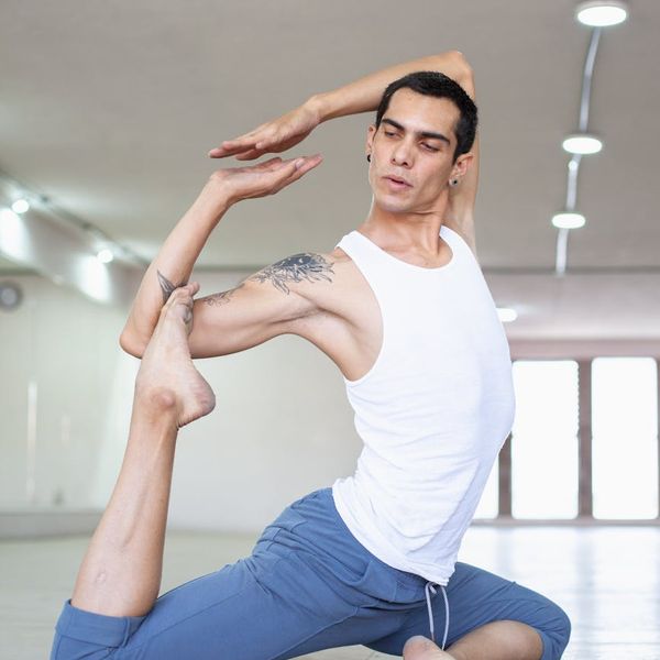 Athlete focused during a kettlebell swing exercise in a minimalist setting.